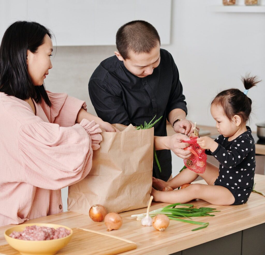 asian family putting away groceries