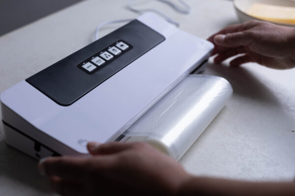 Man using vacuum sealer
