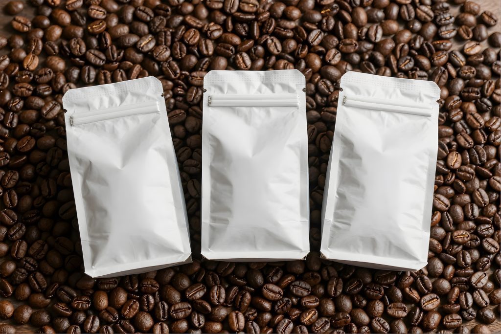 Three vacuum sealed bags on coffee beans